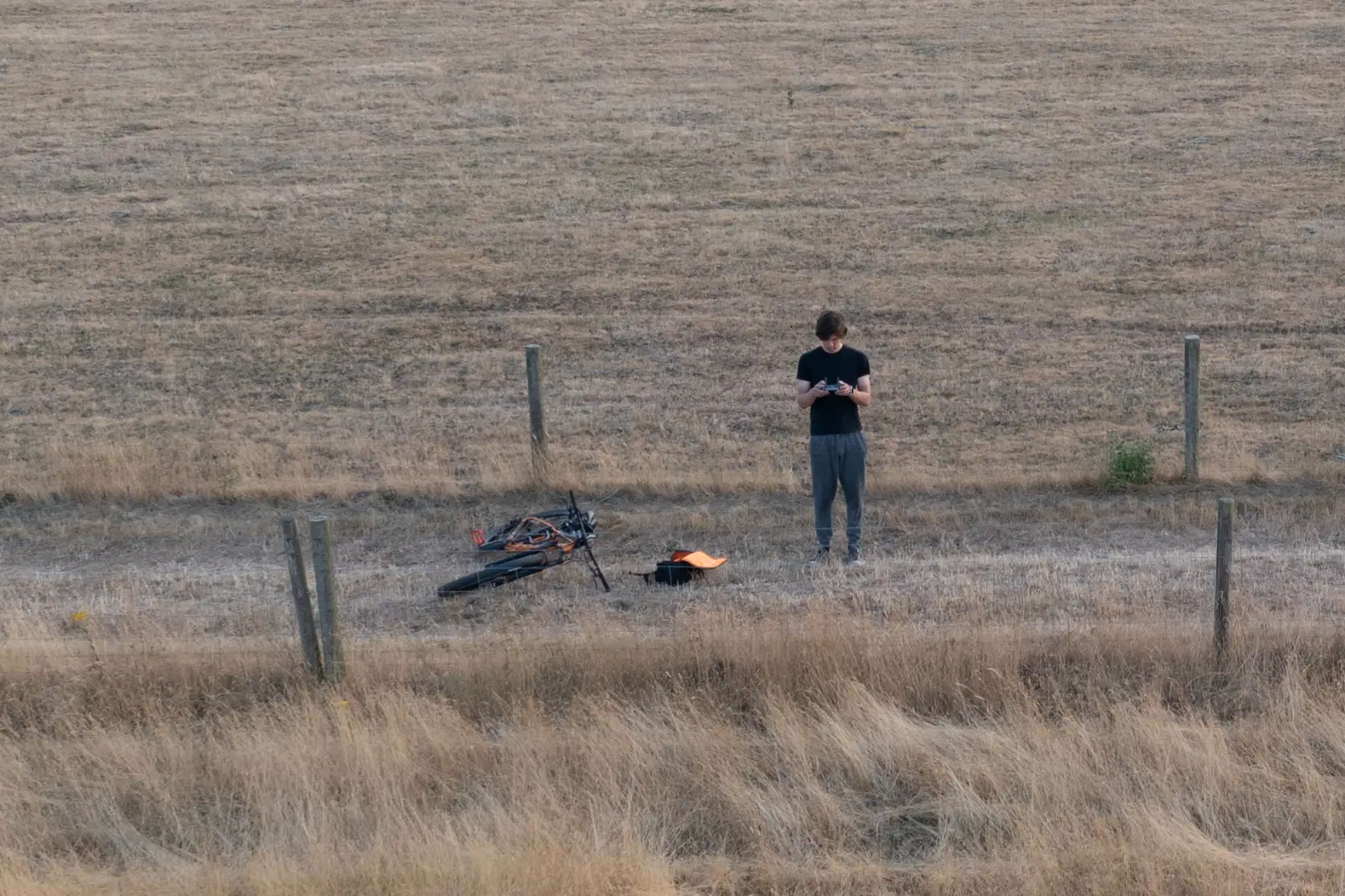 Tom flying his drone in a field, photo taken from above